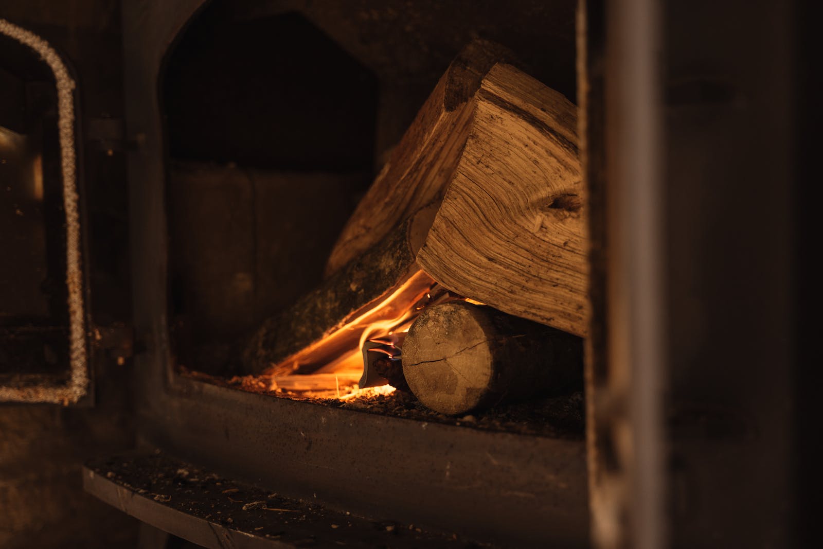 Wood burning in fireplace in dark room