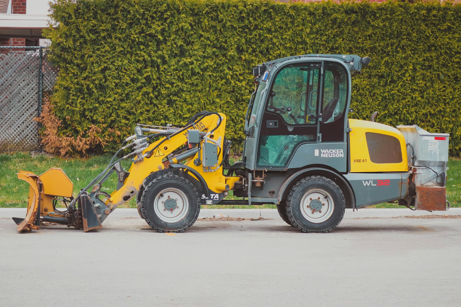 a small construction vehicle parked on the side of the road